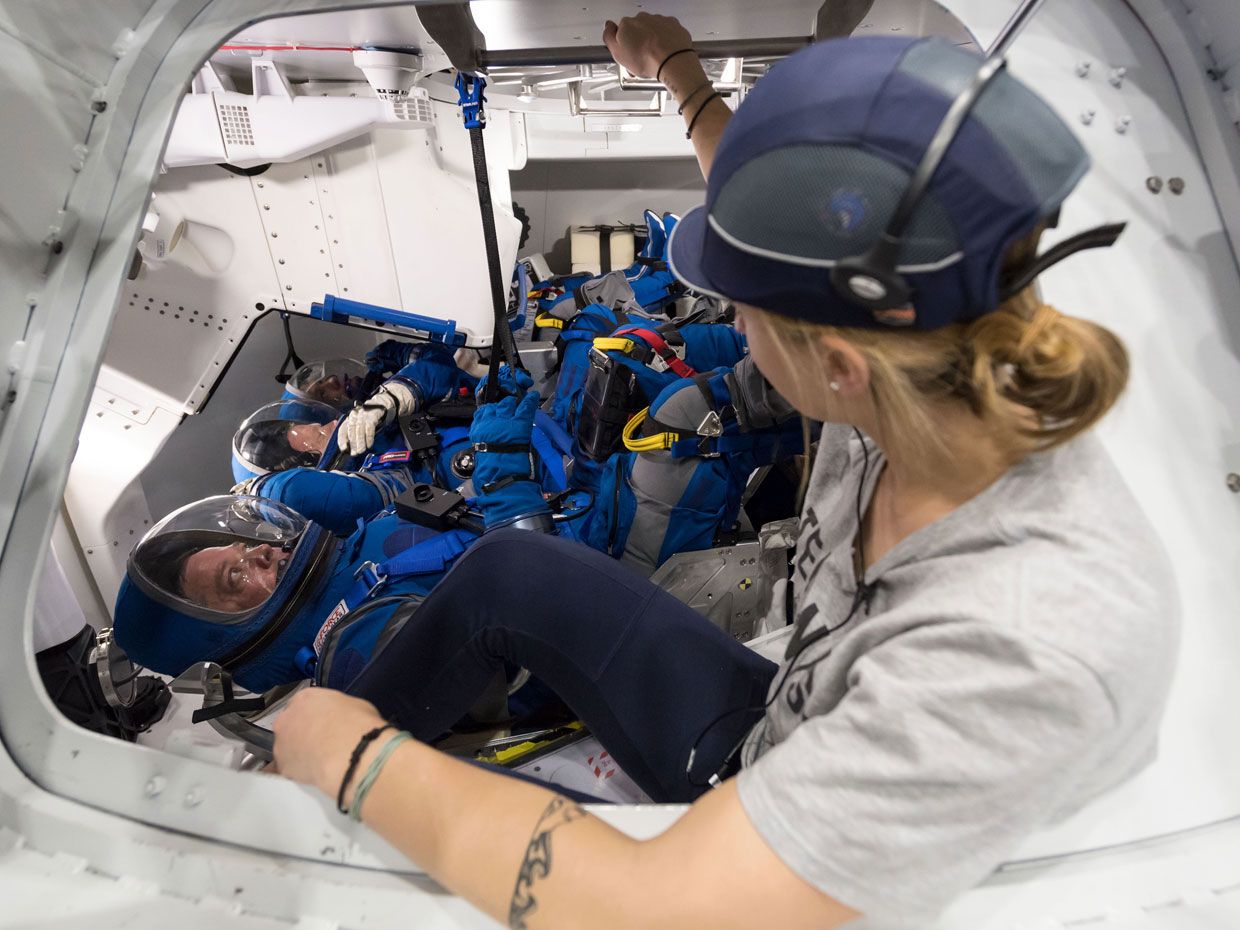   Crews will wear custom blue space suits for Boeing and black-and-white for SpaceX 