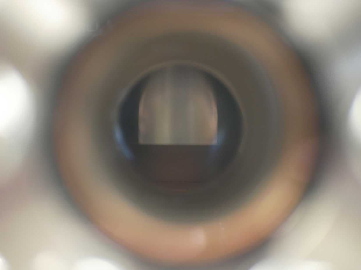 Revterra's flywheel spinning inside the vacuum chamber while magnetically levitated, as seen through a vacuum tight glass window.