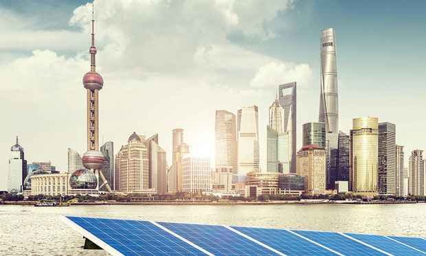 Image of Shanghai's skyline with solar panels in front.