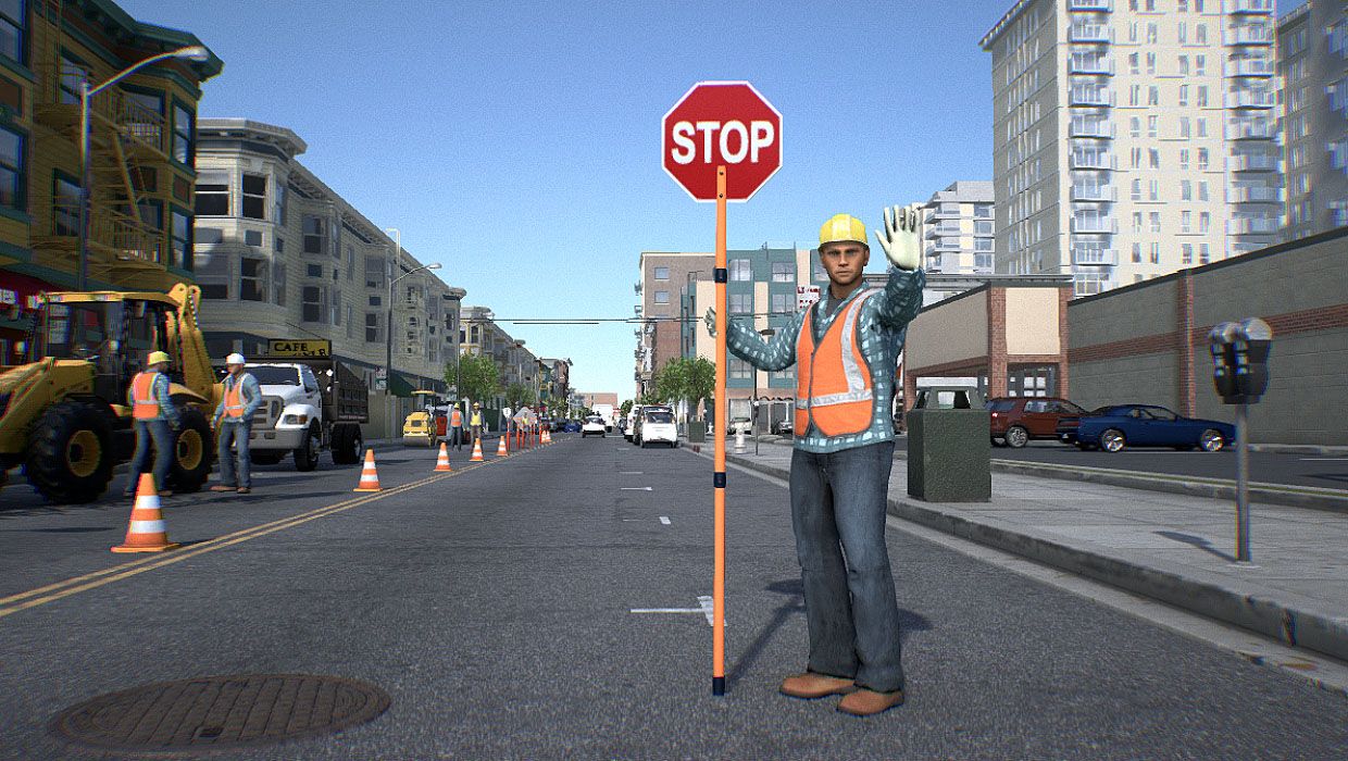 Image of a construction worker holding a "stop" sign. 