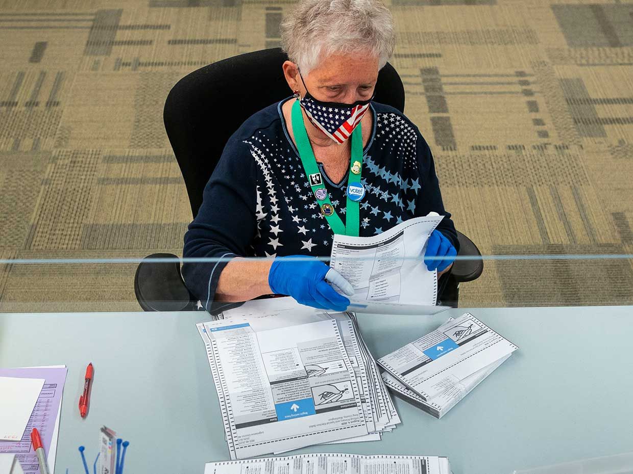 Elections worker Jan Reese opens ballots at the King County Elections headquarters on August 4, 2020 in Renton, Washington. Today is election day for the primary in Washington state, where voting is done almost exclusively by mail. 