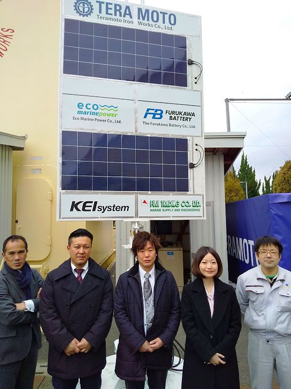 Eco Marine Power partners pose in front of the EnergySail demonstration and test unit at the Onomichi Marine Tech Test Center in Hiroshima Prefecture, Japan, in February 2020.