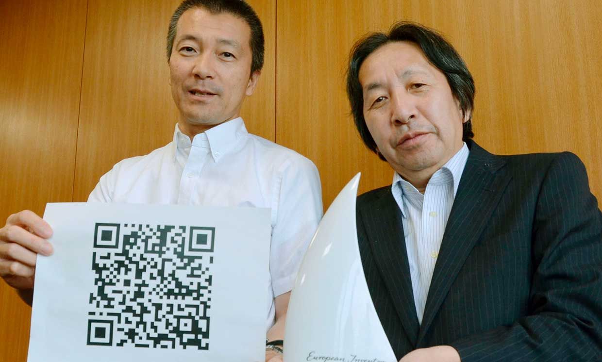 Masahiro Hara (R) of Denso Wave Inc. and Takayuki Nagaya of Toyota Central R&D Labs. Inc. show their Popular Prize awarded by the European Patent Office for their invention of the square "Quick Response Code," or QR code.