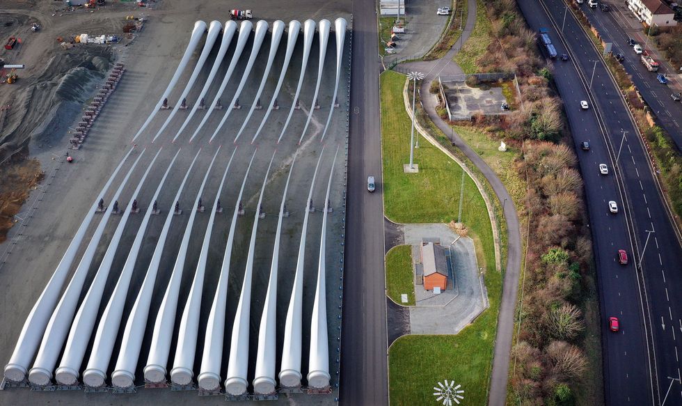 22 giant white fan blades sit parked adjacent to a highway in Hull, northeast England. The blades were manufactured for 20 to 30 years of service generating electricity on wind turbines before theyu2019re broken down and recycled for their next environmentally friendly use.