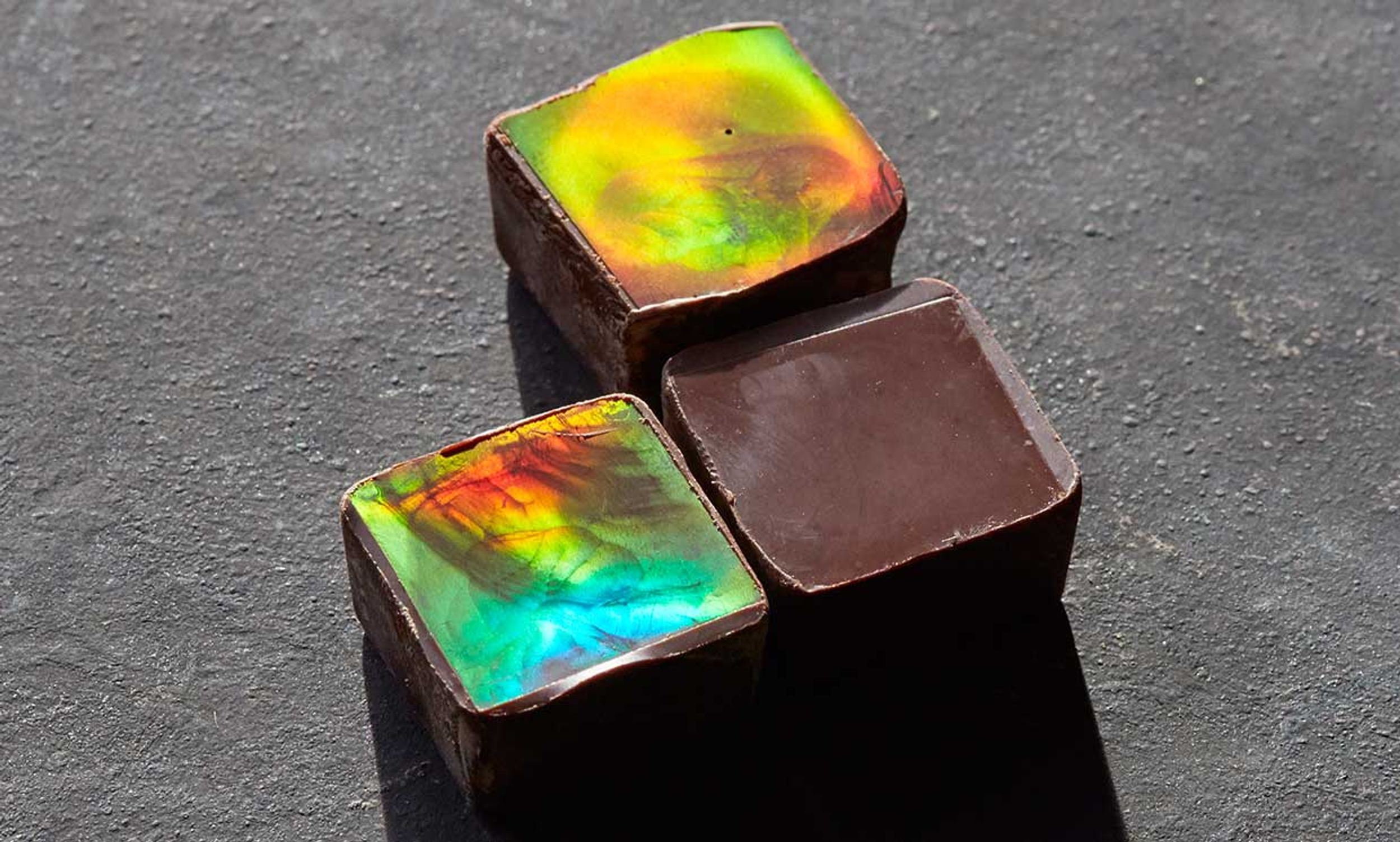 3 pieces of chocolate shimmer due to a special surface imprint that produces what the scientists refer to as a structural colour.