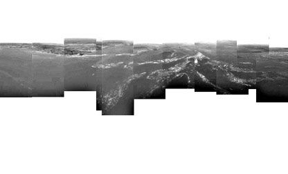 A 360-degree view from the Huygens probe 8 km from the surface of Titan shows a plateau [center] near the landing site. Huygens touched down at the far right of the image, which is thought to be a drainage channel. The white streaks are thought to be a gr
