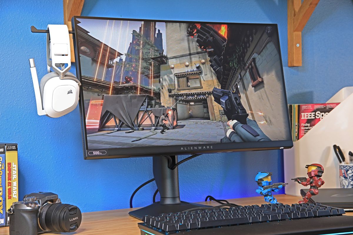 A 500Hz Alienware computer monitor on a desk. A video game is playing on the monitor.