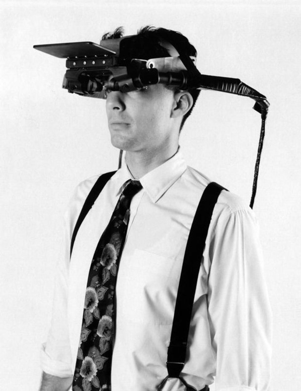 A black and white photo of a man wearing a large head-mounted display
