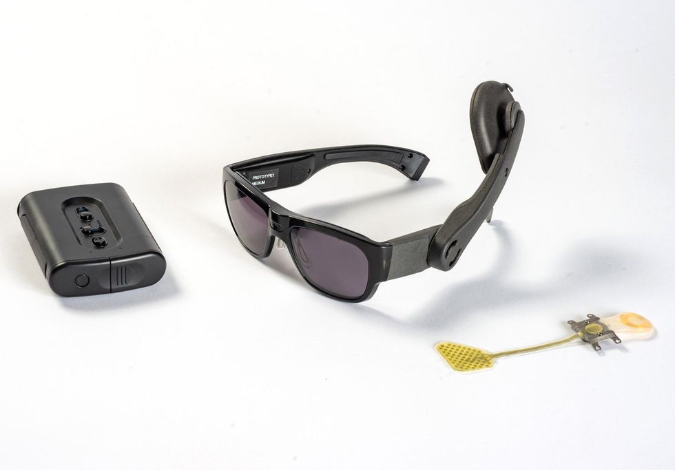 a black box, black sunglasses and a yellow tag on a white background