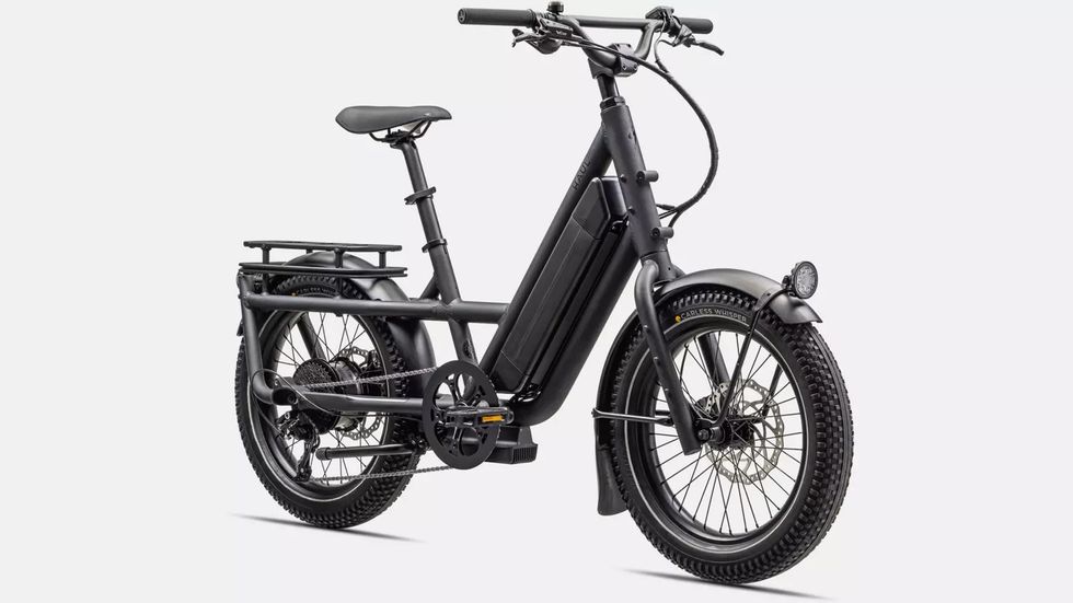 A black electric bike with thick wheels and a black battery under the handlebars