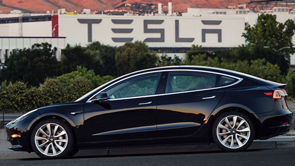 A black Tesla Model 3 all-electric car shown from the side