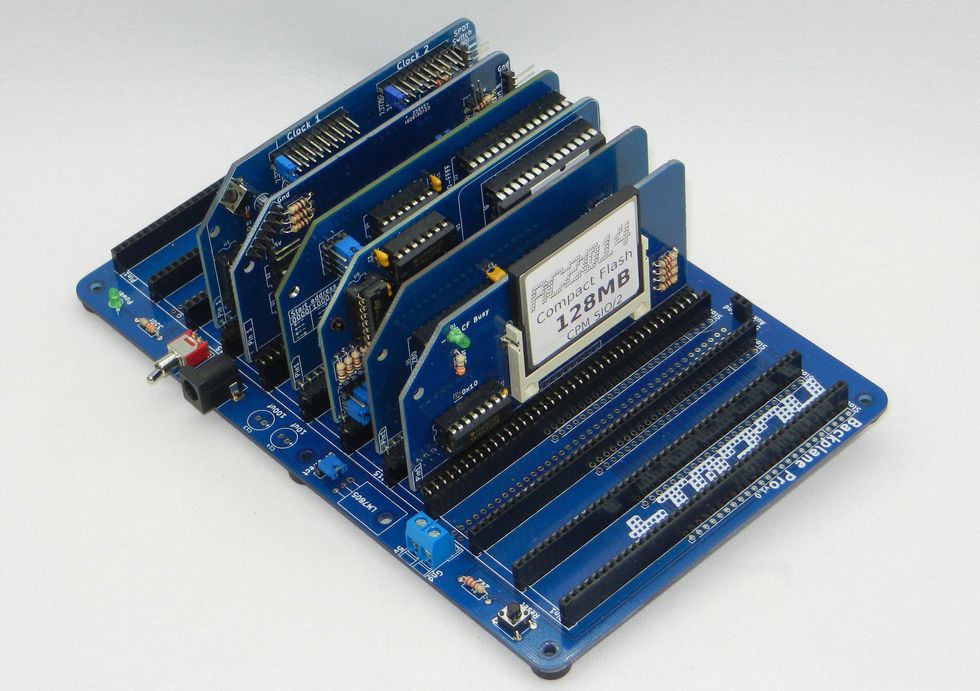 A blue board with a series of vertical boards on top. One has a chip labelled RC2014