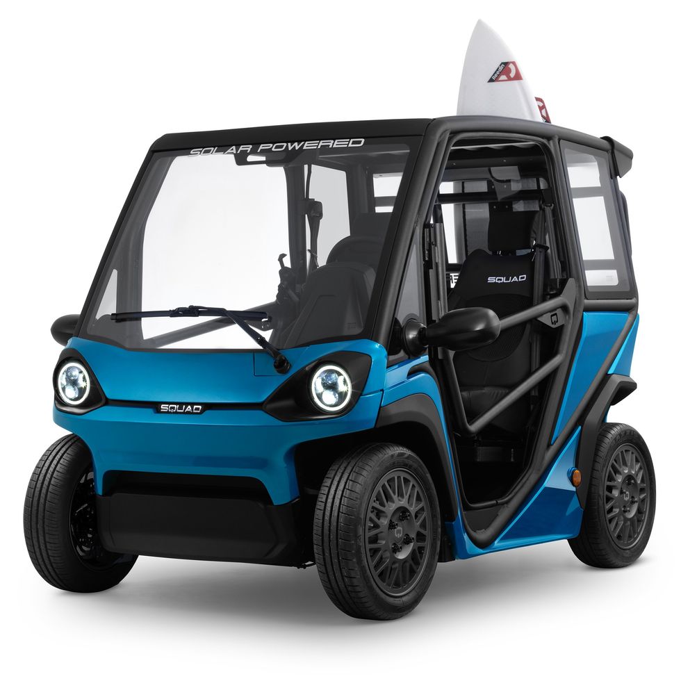 A blue buggy the size of a golf cart with a surfboard in back.