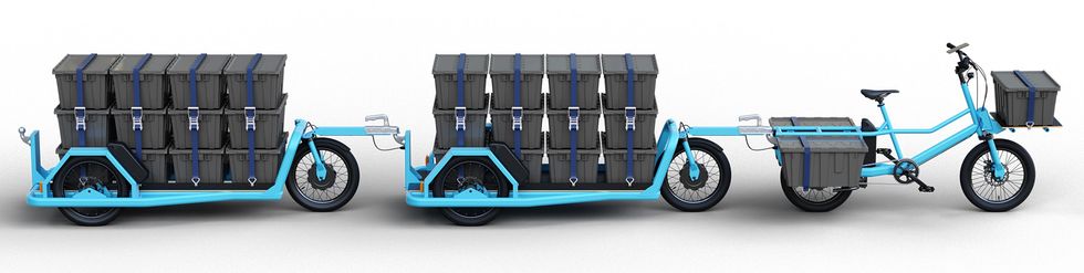 a-blue-framed-bike-and-two-trailers-behi