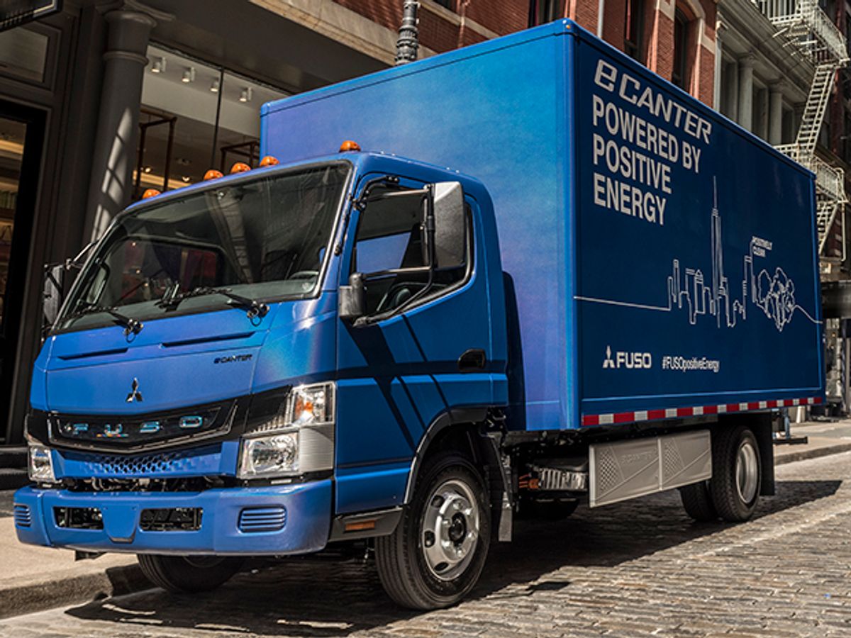A blue, medium-sized truck with the words "eCanter Powered by Positive Energy" on the side