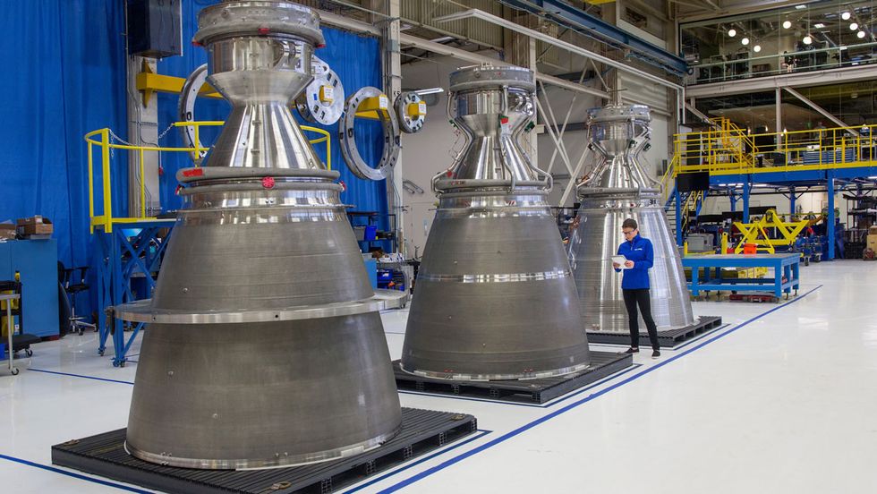 A Blue Origin worker inspects these giant nozzles destined to become part of the company\u2019s new BE-4 rocket engines.