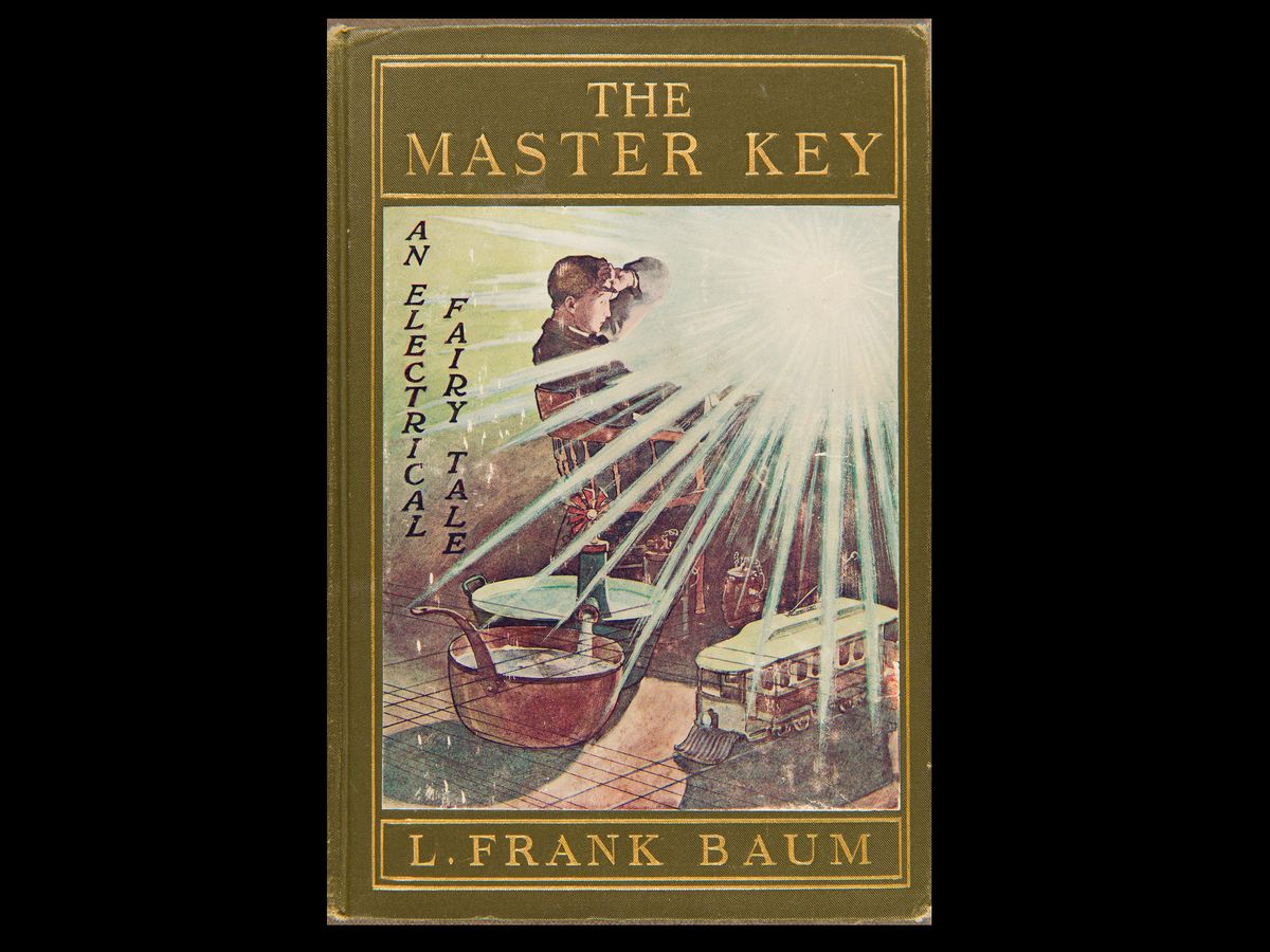 A book titled The Master Key: An Electrical Fairy Tale by L. Frank Baum. On the cover, a male sits in a chair while a vibrant light shines at him.