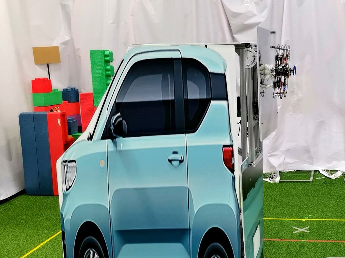 a box with a picture of a small teal car in front of a white backdrop, and a drone attached to the box's back