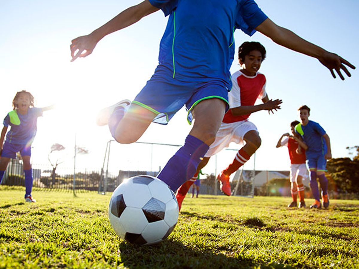 A child chases a ball during a soccer game. These kinds of images would be easier to capture by networking smartphones and adding motion trackers to the kids, says startup Peeq