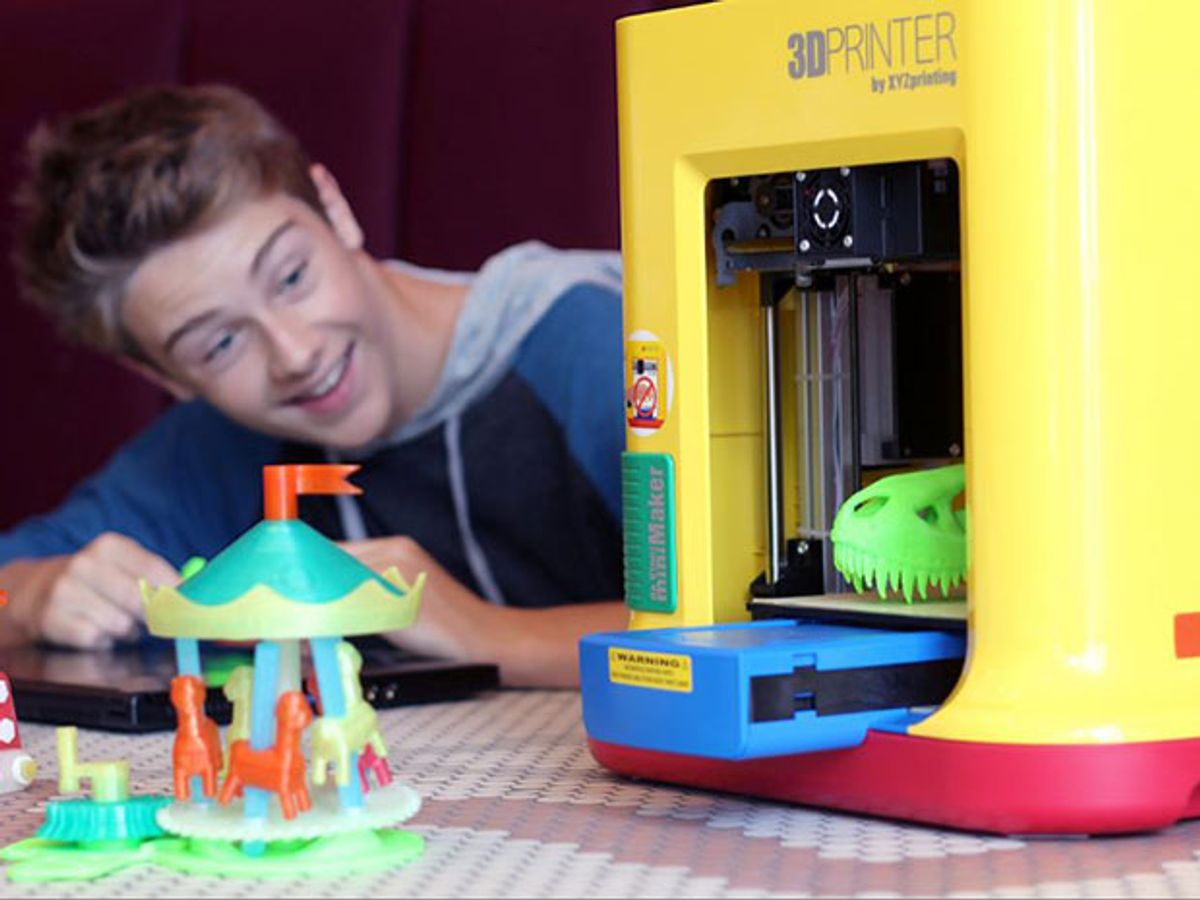 A child checks out the $250 da Vinci MiniMaker, a 3D printer for kids from XYZprinting, along with a printed merry-go-round