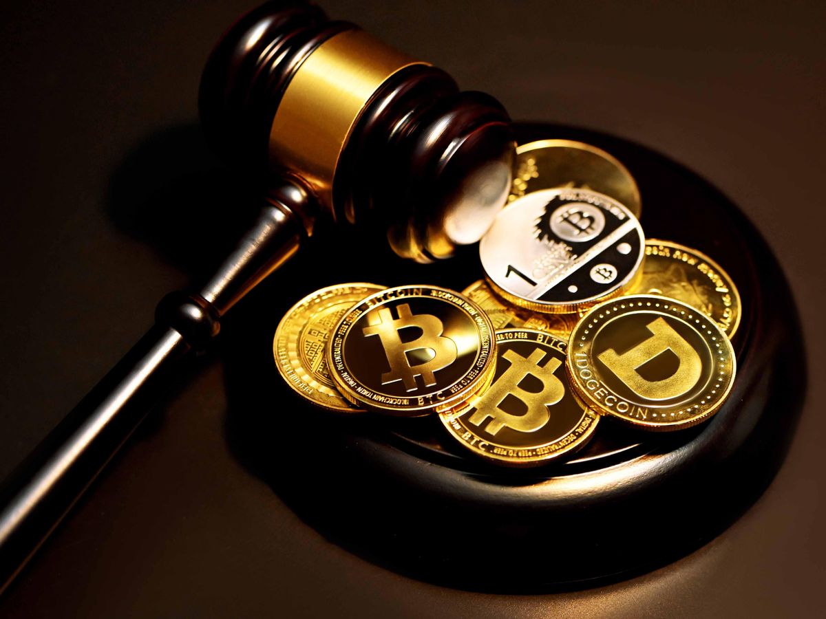 A collection of cryptocurrency coins with a gavel