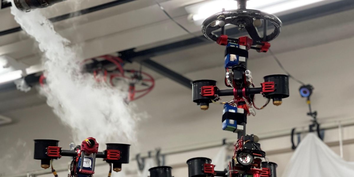 a complex aerial robot made of multiple segments of actuators and ducted fans grasps and turns a valve near a ceiling