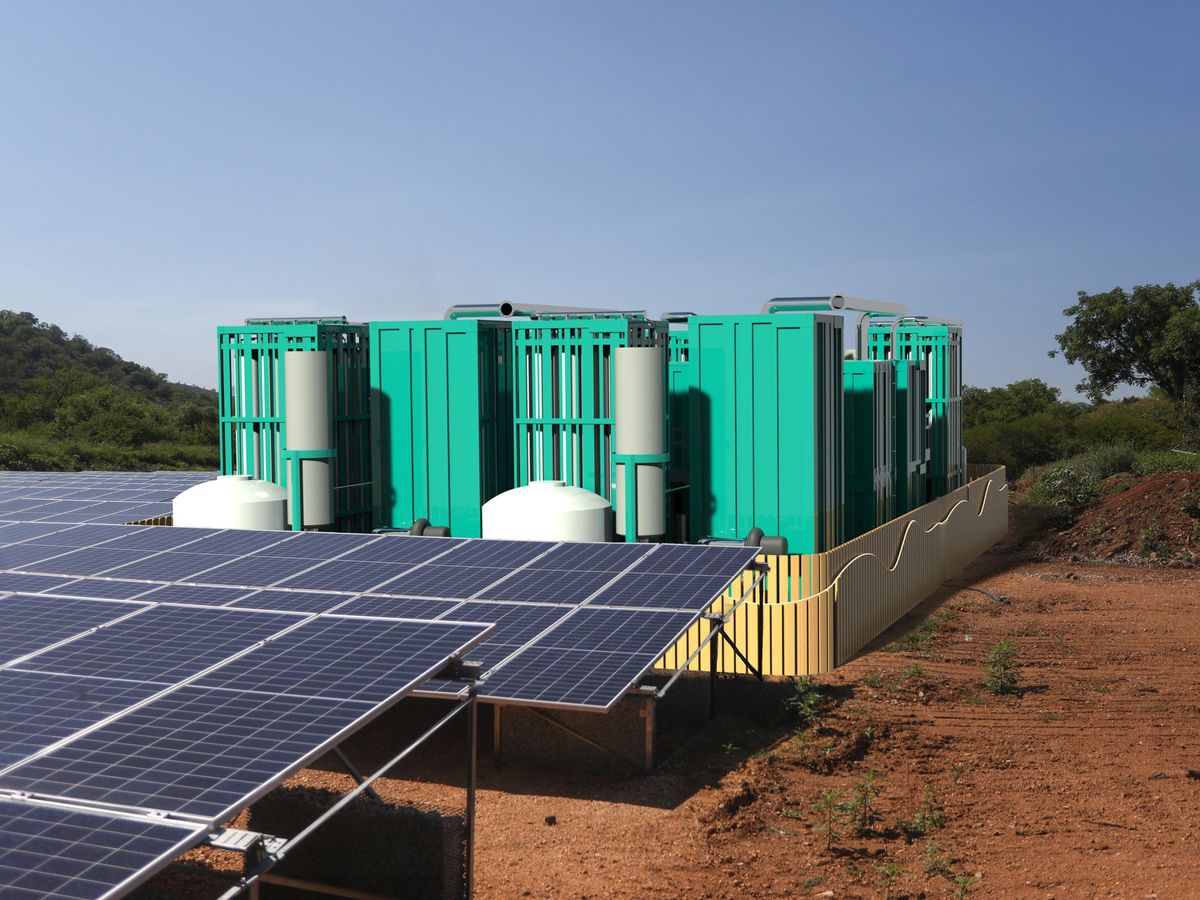 a computer rendering showing a large teal box behind a short yellow fence. In front of the box are rows of solar panels. The entire setup is on a patch of dirt.
