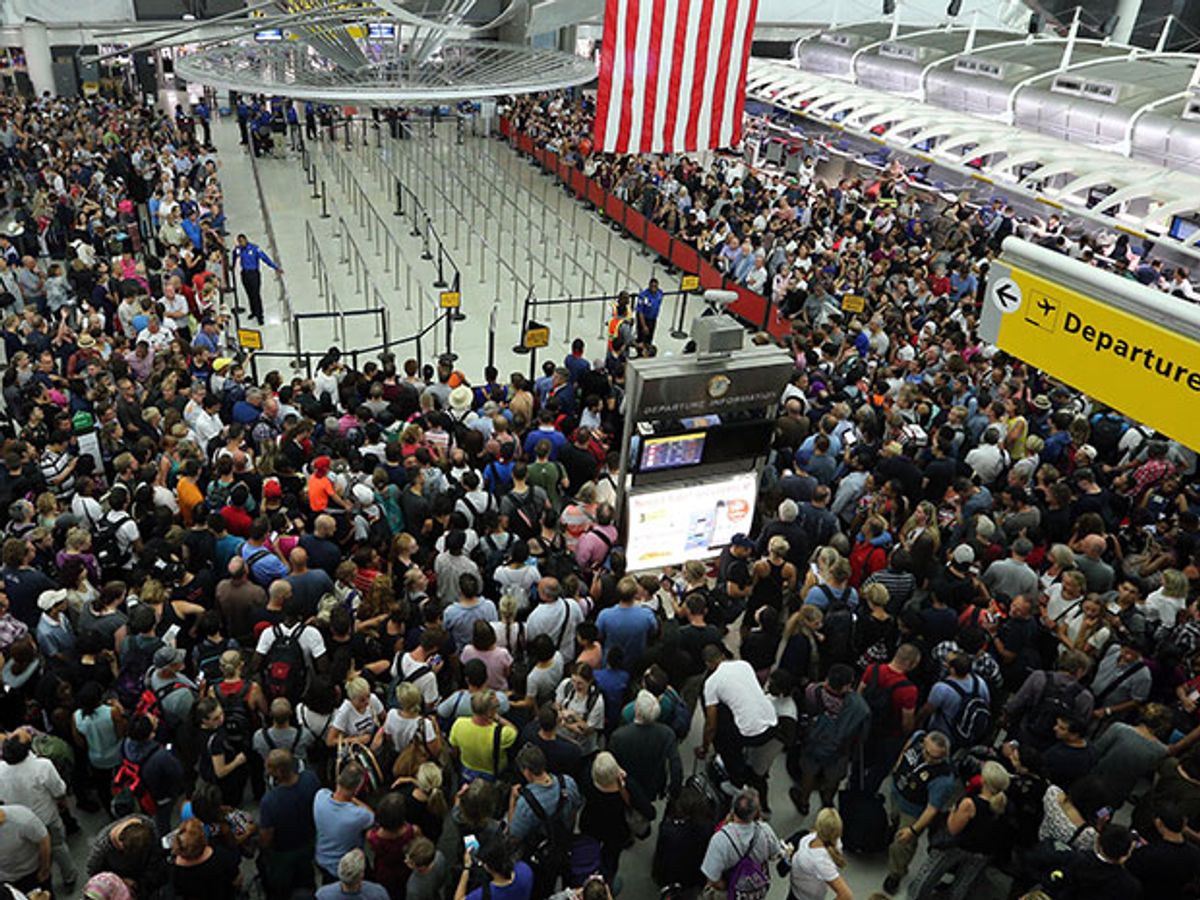 A crowd waits at JFK International Airport due to reports of shooting inside a terminal