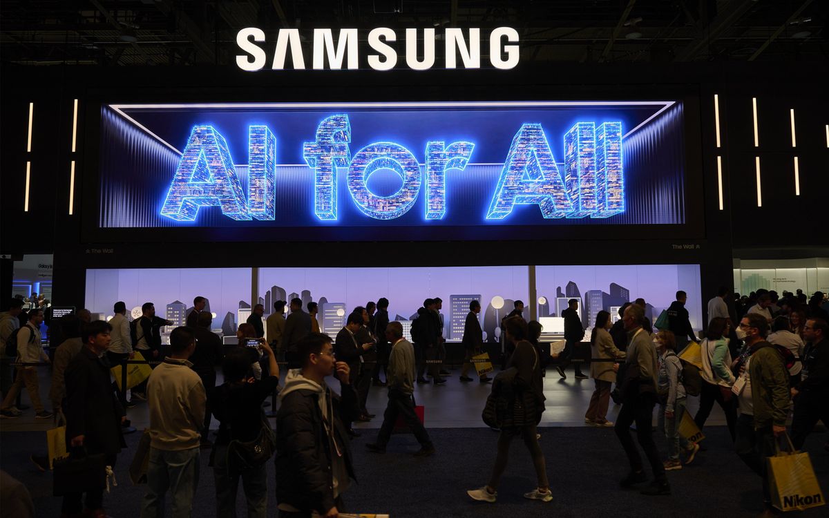 A crowded tradeshow floor with a Samsung booth and large glowing words saying AI for All.