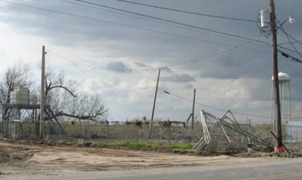 A DLC cabinet system (left), seen here after Hurricane Gustav in 2008, replaced the Yscloskey central office building. The seaweed draping the fence was carried there by the hurricane\u2019s storm surge.