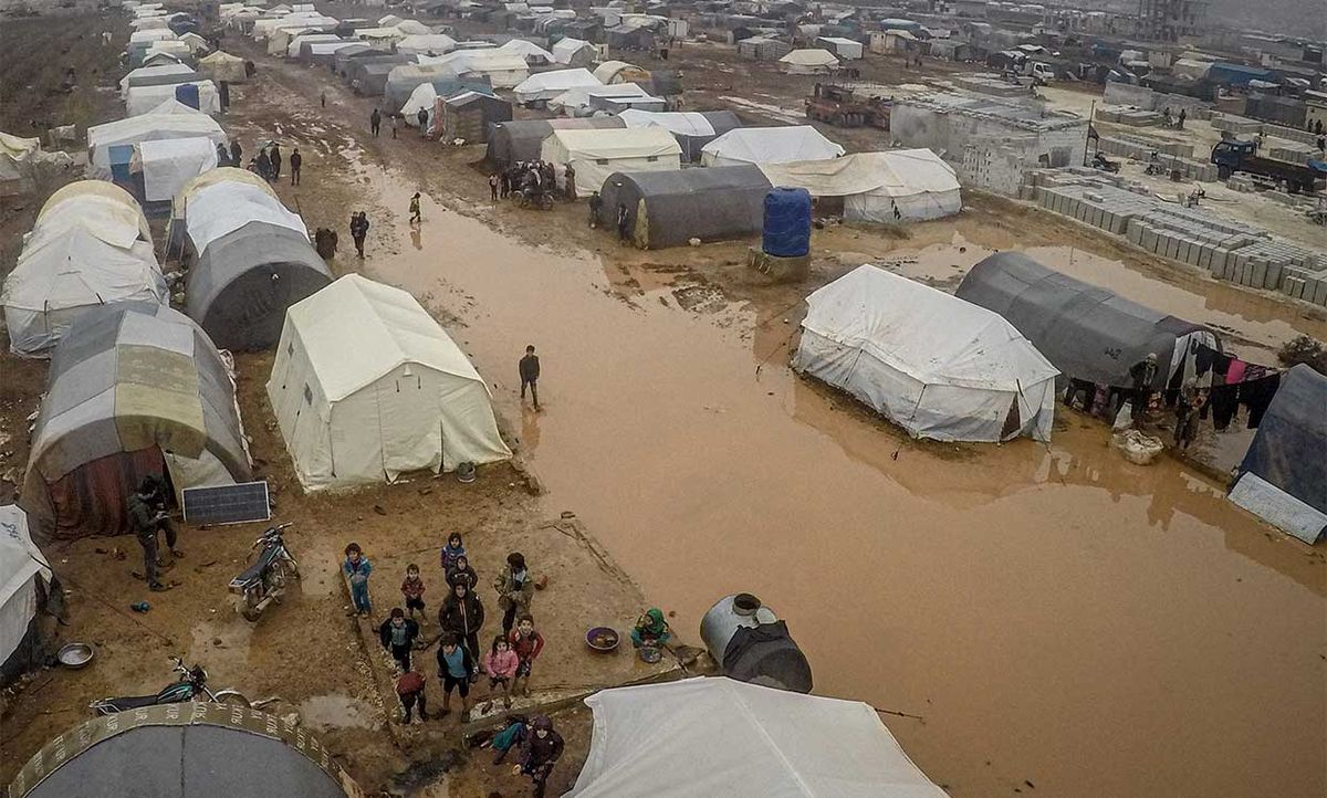A drone photo shows an aerial view of the mud covered road and tents at a refugee camp, where Syrian refugees live, after heavy rain at winter season in northeastern Idlib, Syria on December 13, 2019.