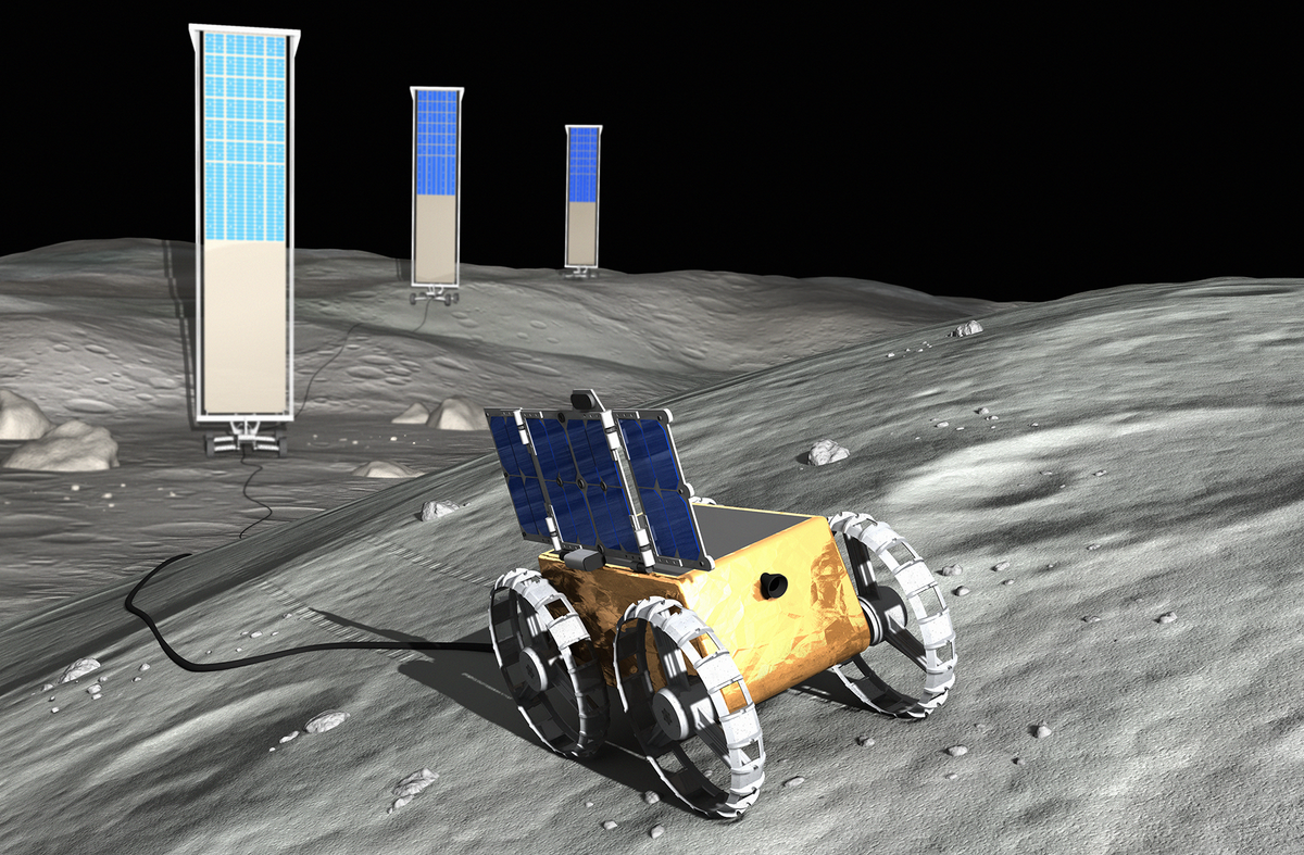 a gold-colored cube mounted on four wheels and bearing on its top a four-panel vertical structure is shown moving up a crater-pocked lunar hill, trailing a cable that connects to three tall vertical panels in the background 
