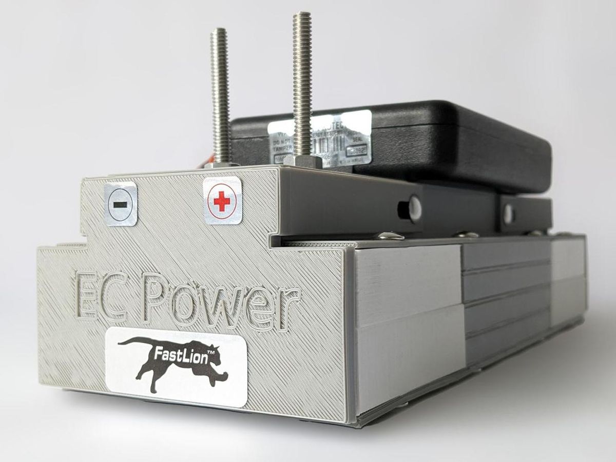 A grey box labeled EC Power with a minus and plus sticker on the side and equipment on top.