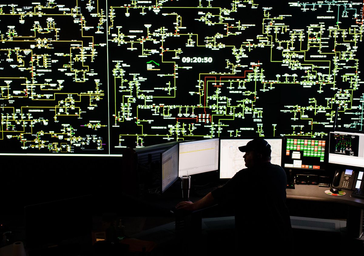 ​A grid operator works in a control room.