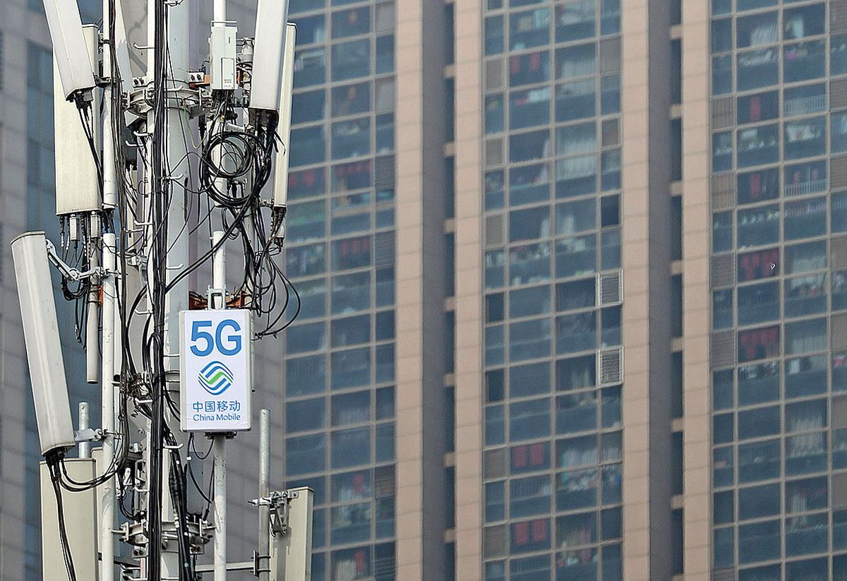 A group of cellular antenna with a sign for "China Mobile" and "5G."