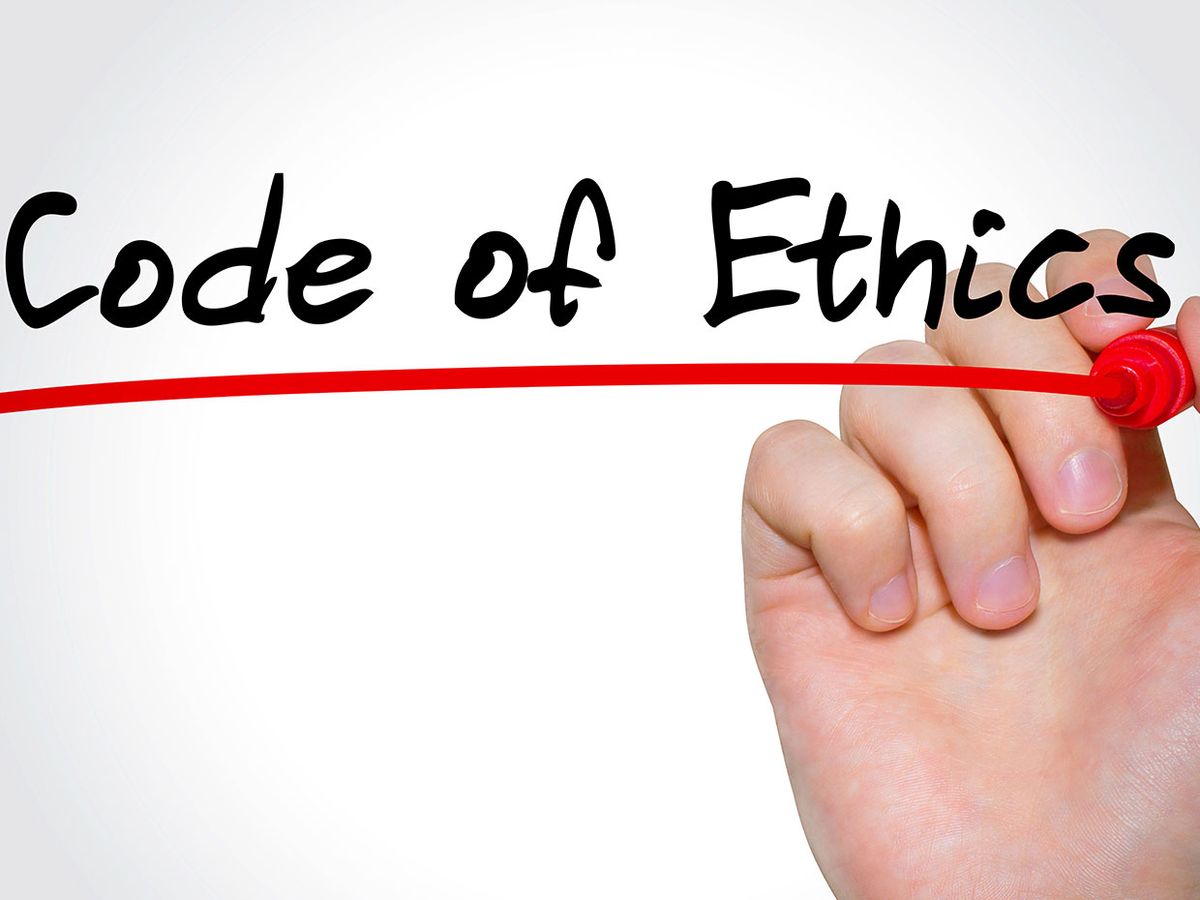 A hand holding a red marker underlines the words Code of Ethics