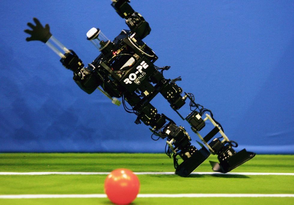 A humanoid robot of the children size league attempts a save during the Robocup 2006 football world championships at the Congress Centre on June 14, 2006 in Bremen.