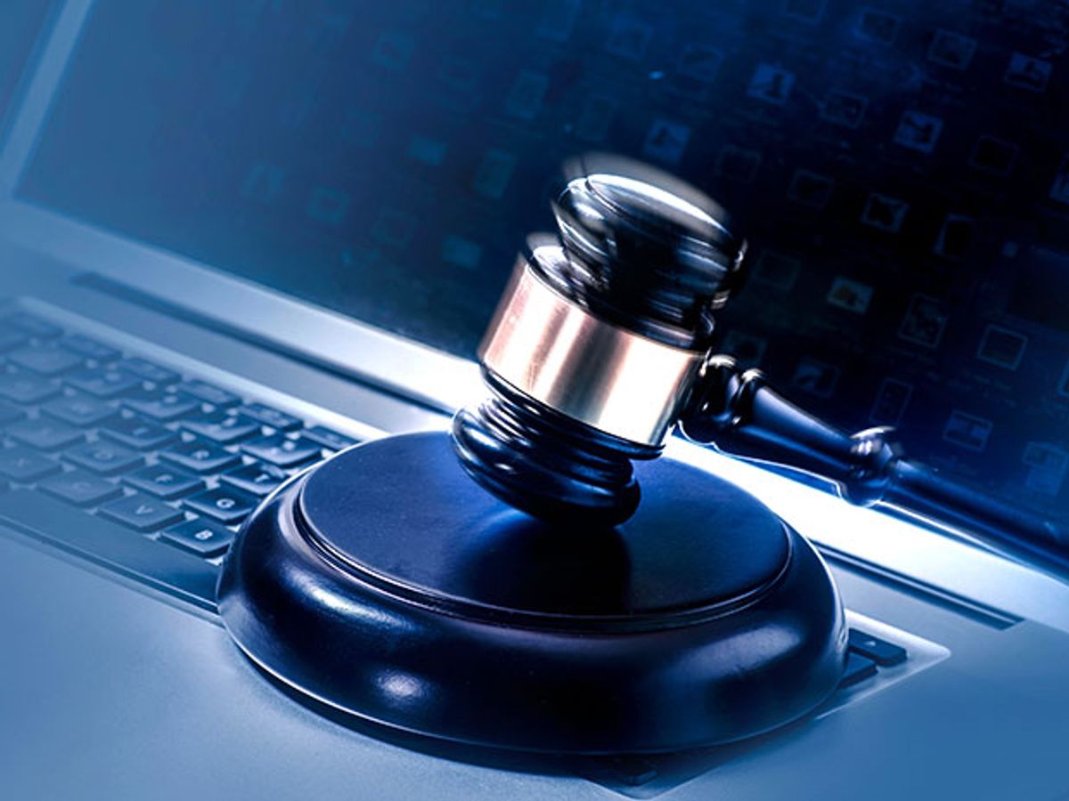 A judge's gavel on a laptop computer
