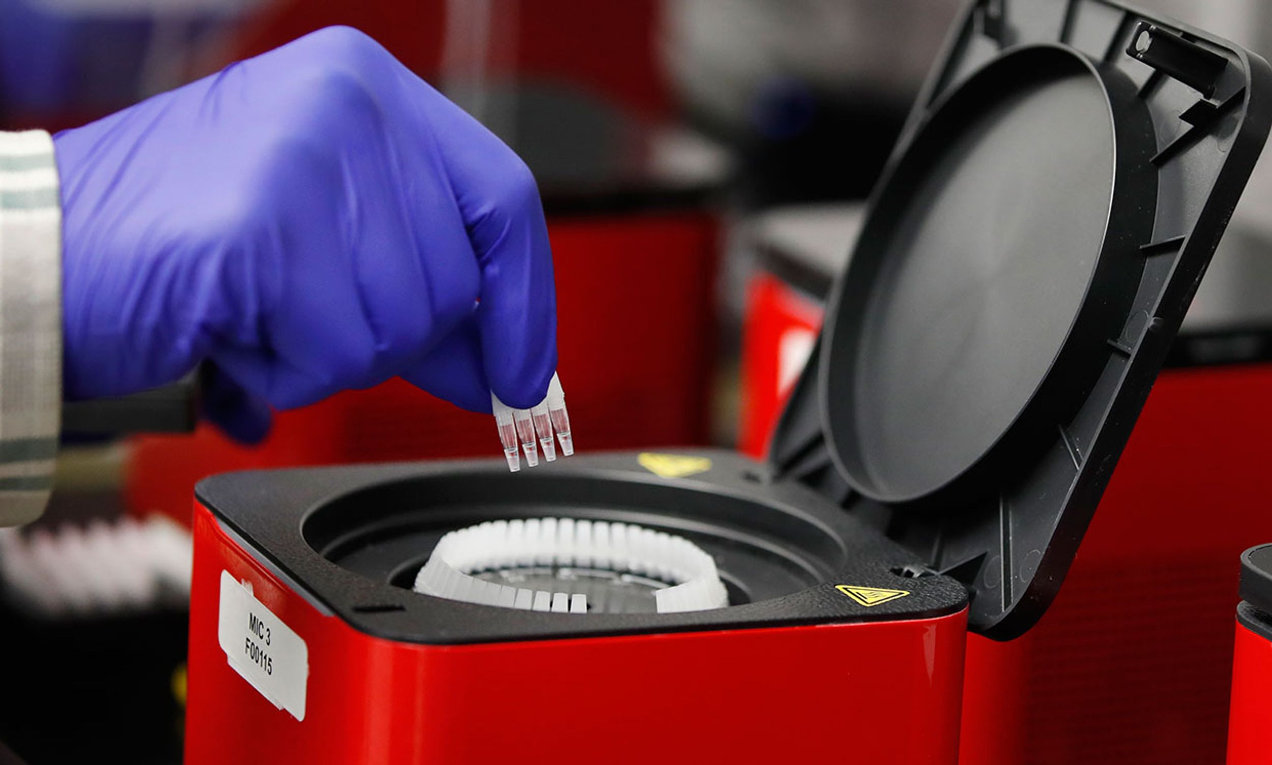 A lab technician adds vials to a Covid-19 polymerase chain reaction (PCR) testing device at a Co-Diagnostics Inc. facility in Salt Lake City, Utah, U.S., on Tuesday, March 24, 2020. 