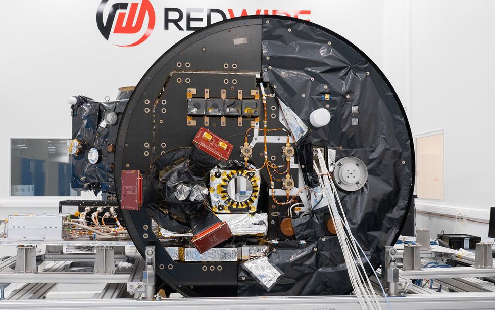 A large circular aerospace instrument with equipment and panels.