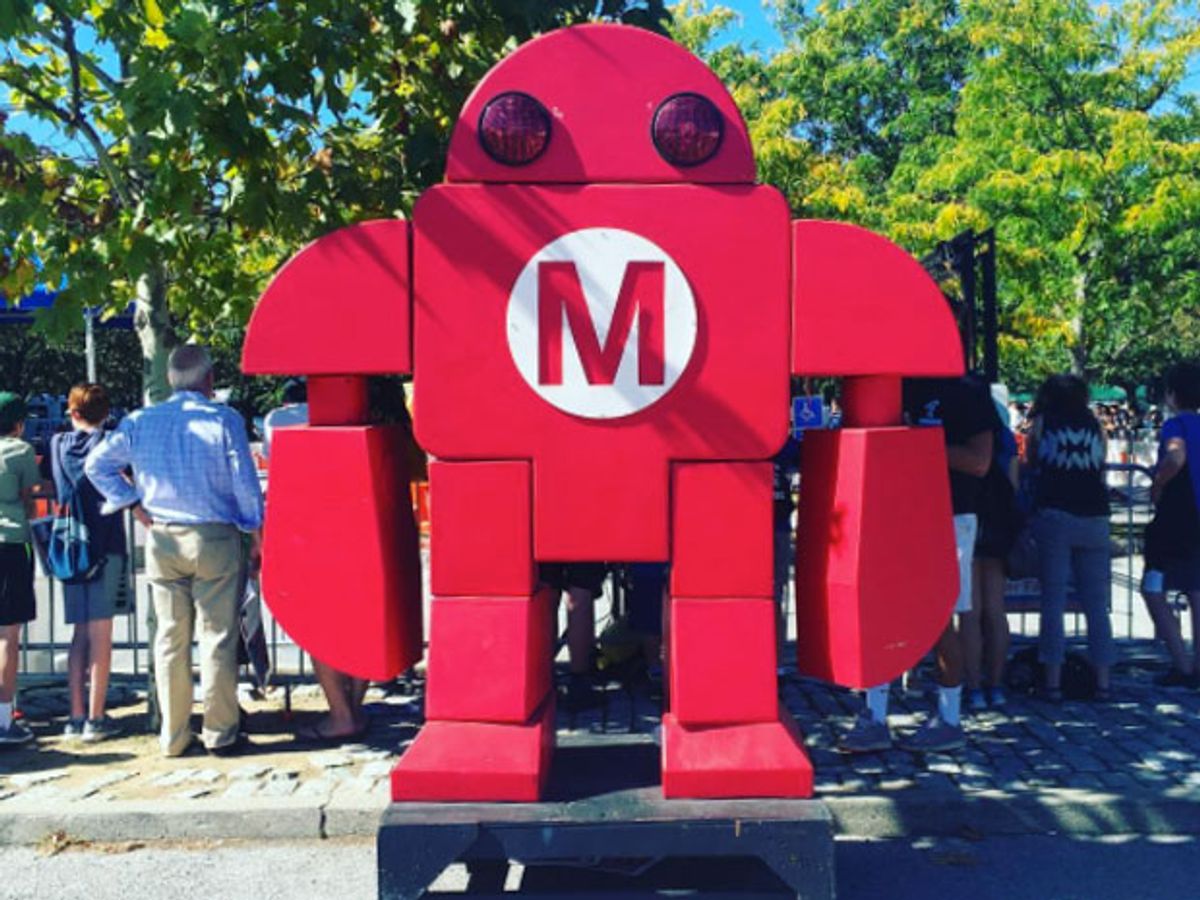 A large red humanoid figure with a red M on it's chest.