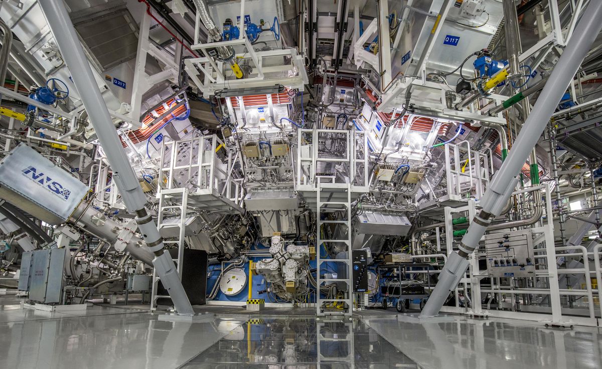 A large, white room filled with complicated equipment, all oriented toward the same point in the center of the image.