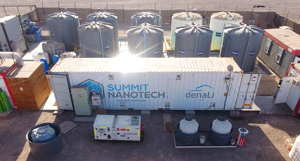 A large white trailer labelled Summit Nanotech is surrounded outside by large storage tanks and other equipment.