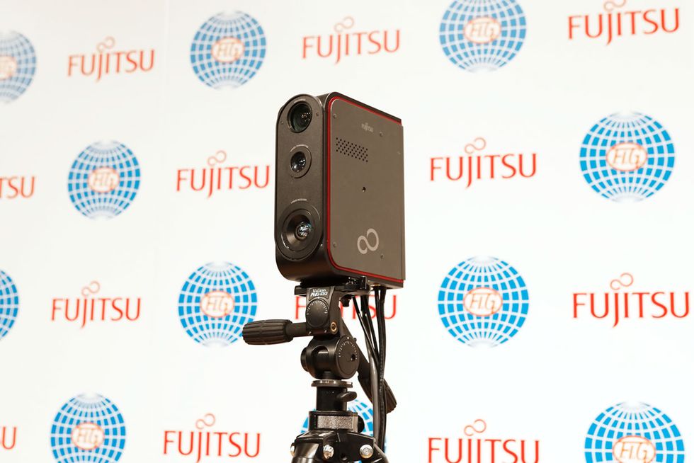 A lidar sensor against a backdrop that says Fujitsu. 