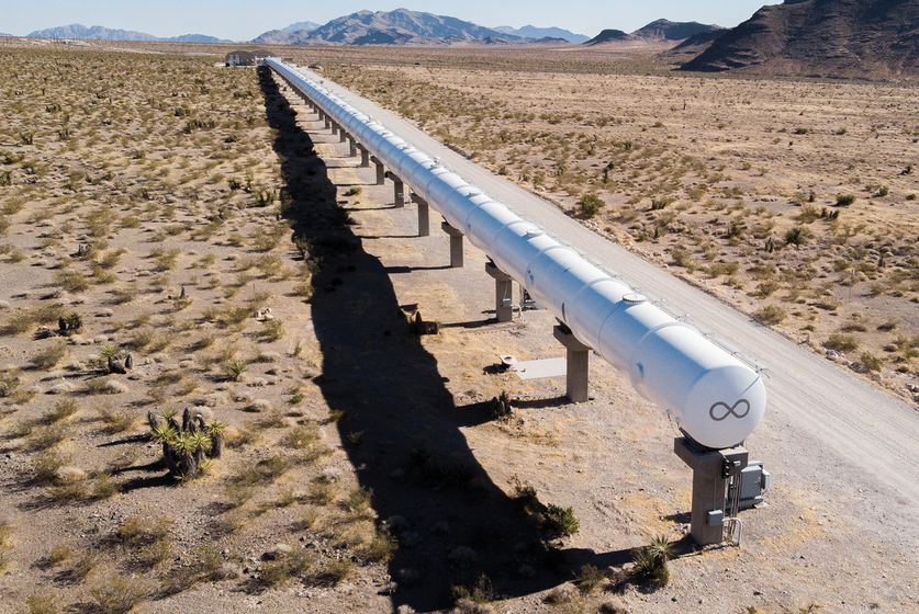 A long white tube in the middle of the desert.