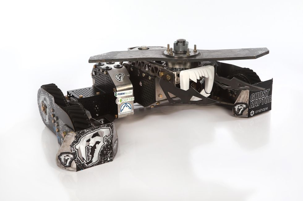 A low-slung tracked robot with a spinning blade on top