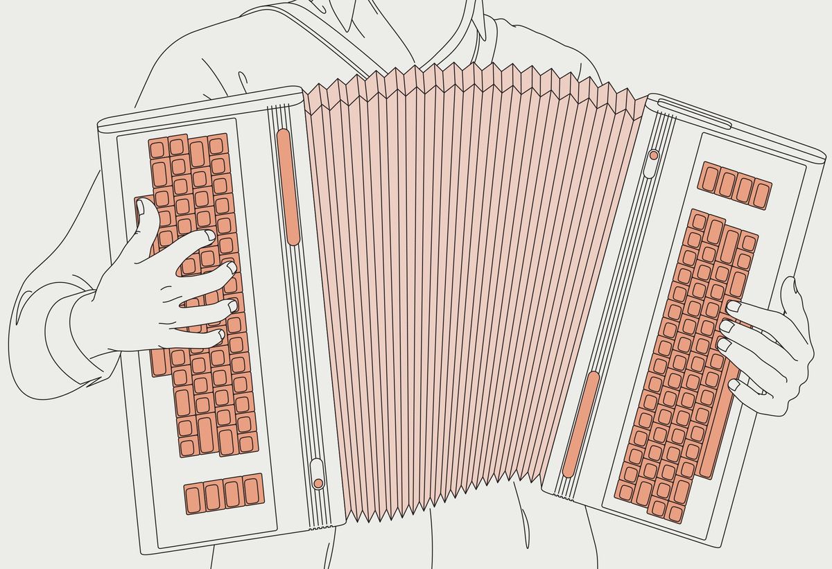 A man holding an instrument made of two Commodore 64 computers separated by a corrugated accordion bellows.