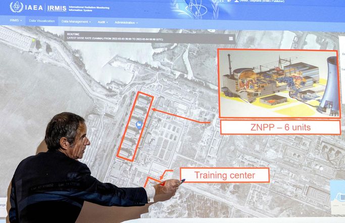 A man stands in front of a projection showing an overview of a facility. He is pointing to a label that says "training center." Another box is labeled "ZNPP \u2014 6 units."