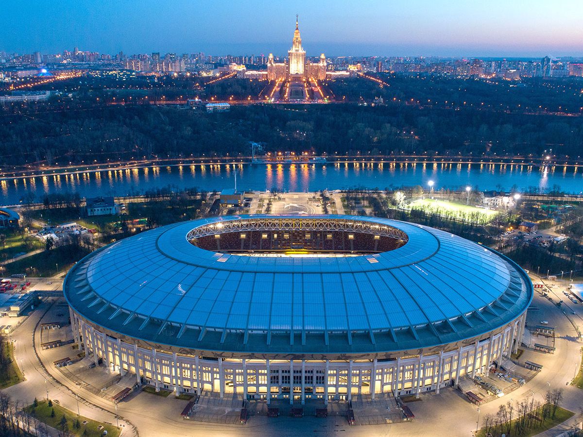 A nighttime aerial view of Luzhniki Stadium, a venue for 2018 FIFA World Cup matches.