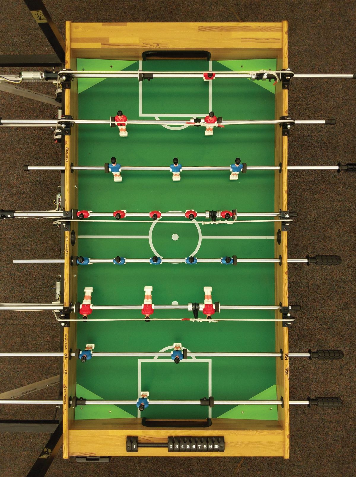 A overhead shot looking down at a foosball table. 